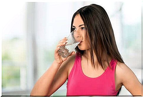 Woman hydrating to avoid chronic constipation