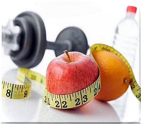 Dumbbells, an apple and an orange