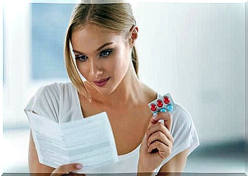 A woman reading the side effects of a drug